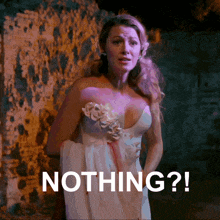 a woman in a white dress is standing in front of a wall with the words nothing written below her