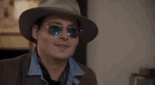 a man wearing a hat and sunglasses is saying how great for y .