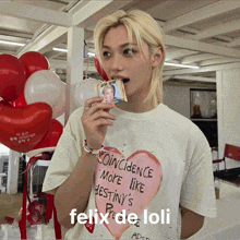 felix de loli is wearing a white t-shirt with a pink heart on it