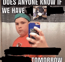 a boy taking a selfie with a phone that says " does anyone know if we have tomorrow "