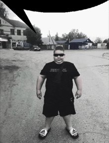 a boy wearing a just do it shirt and adidas slides