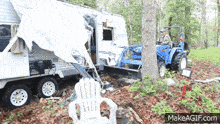 a man is driving a tractor next to a trailer that has been destroyed