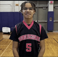 a young man wearing a wisconsin precision prep basketball jersey