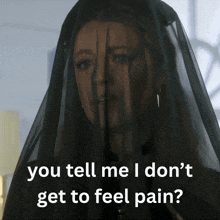 a woman wearing a black veil with the words you tell me i don 't get to feel pain
