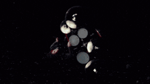 a man playing drums in a dark room with smoke coming out of it