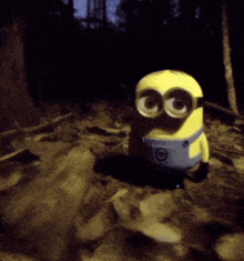 a yellow minion with big eyes is standing in a dark area