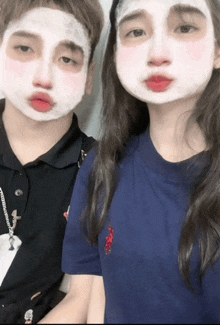 a boy and a girl with white face masks on their faces