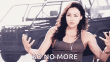 a woman is sitting in front of a car with her hands outstretched and the words `` so no more '' .