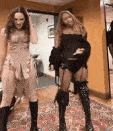a couple of women are standing next to each other on a rug .