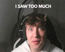 a man wearing headphones with the words i saw too much behind him