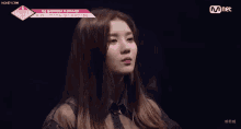 a close up of a woman 's face with a mnet logo on the bottom
