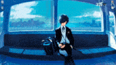 a man in a suit sits in front of a window with the date 3/26 on the bottom