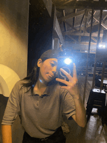a person taking a selfie with a pepsi logo on the phone