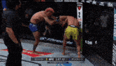 two men are fighting in a boxing ring with the ufc 1:27 on the display