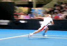 a blurred image of a tennis player running on a court