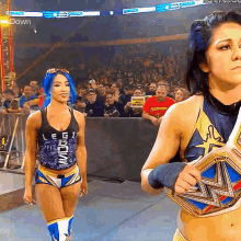 a female wrestler wearing a shirt that says legion