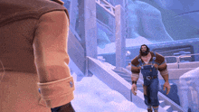 a man in overalls and a brown jacket stands in the snow
