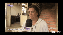 a woman talking into a microphone with the words made with flixier on the bottom right
