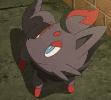 a black and red cartoon animal with blue eyes