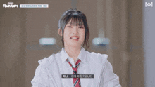a girl in a white shirt and tie is giving the peace sign