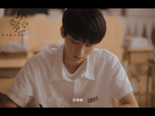 a young man in a white shirt has a name tag that says ' ea ' on it