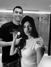 a black and white photo of a man and woman