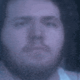 a blurry picture of a person 's face with their eyes closed in the dark .