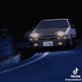 a close up of a yellow sports car with a black hood and a tiktok watermark