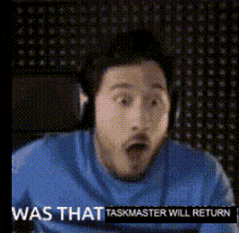 a man wearing headphones and a blue sweater says was that taskmaster will return
