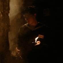 a man in a dark room has a tag on his sleeve that says ' lg ' on it