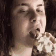 a close up of a person eating a waffle with whipped cream on it .