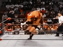 a wrestler in a ring with a referee watching