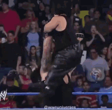 a man in a wrestling ring with a sign that says t