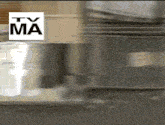 a tv ma logo is above a blurred image of a kitchen