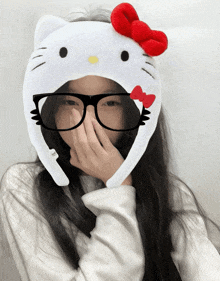 a girl wearing a hello kitty hat and glasses