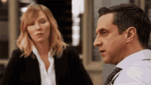 a man and a woman are having a conversation in a room