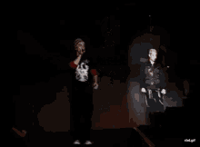 a man wearing a black shirt with the word salute on it is dancing on a stage .