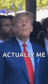 a man in a suit and tie is standing in front of a crowd .