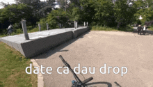 a bicycle is parked on the side of a road with the words date ca dau drop written on the bottom