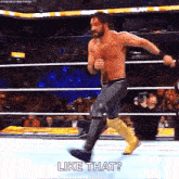 a shirtless wrestler is jumping in the air in a wrestling ring while saying `` like that '' .