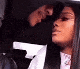 a man and a woman are sitting in a car and kissing .