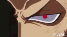 a close up of a man 's face with a red eye and a beard .