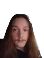 a young man with long hair and a moustache looks at the camera