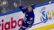a hockey player with the number 16 on his jersey celebrates