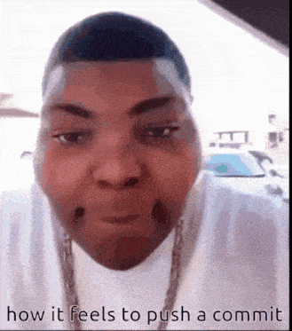 a close up of a man 's face with the words `` how it feels to push a commit '' below him .