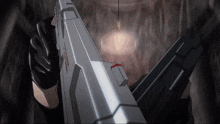 a person holding a gun with a red stripe on it
