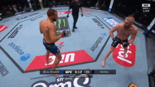 two men are fighting in a boxing ring with ufc 3:12 on the clock
