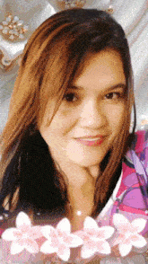 a woman 's face is surrounded by flowers and is smiling