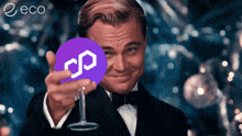 a man in a tuxedo is holding a purple coin with a s on it in front of his face