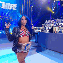 a woman with blue hair is on a stage with the word time in the back